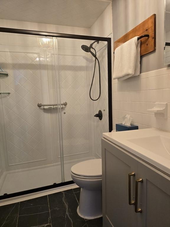 68 Lake Shore Dr, West Brookfield, MA 01585 - bathroom featuring vanity, a shower stall, and marble finish floors