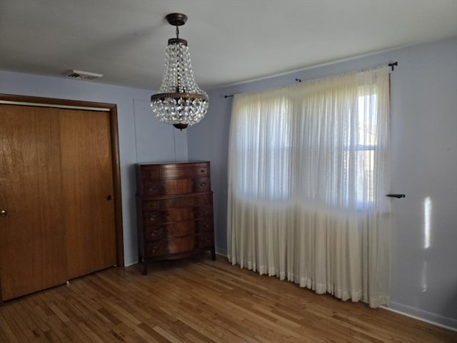 68 Lake Shore Dr, West Brookfield, MA 01585 - unfurnished bedroom with a chandelier, wood finished floors, and a closet