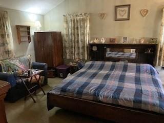 carpeted bedroom with vaulted ceiling