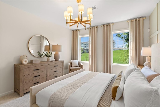 carpeted bedroom with multiple windows and a chandelier