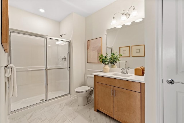 bathroom featuring vanity, toilet, and a shower with shower door