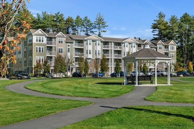 surrounding community with a gazebo and a lawn