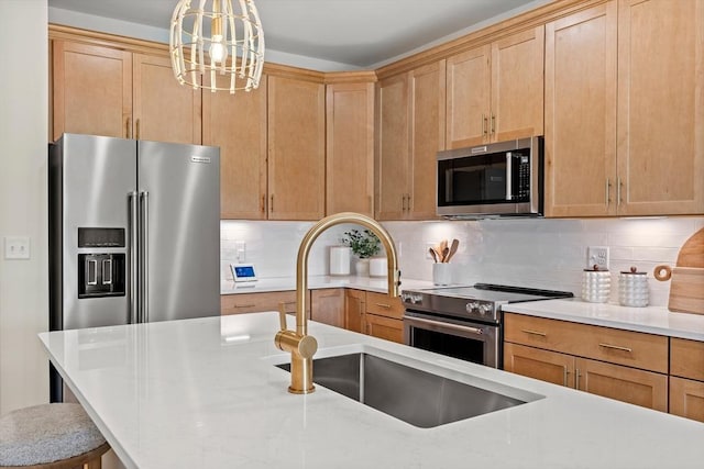 kitchen with light brown cabinets, an inviting chandelier, decorative backsplash, appliances with stainless steel finishes, and decorative light fixtures