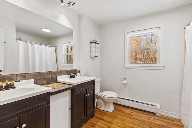 bathroom featuring a baseboard radiator, vanity, toilet, and wood-type flooring