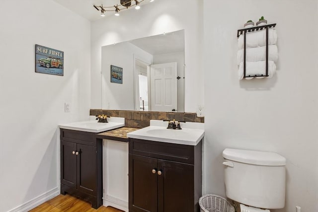 bathroom with vanity, hardwood / wood-style floors, and toilet