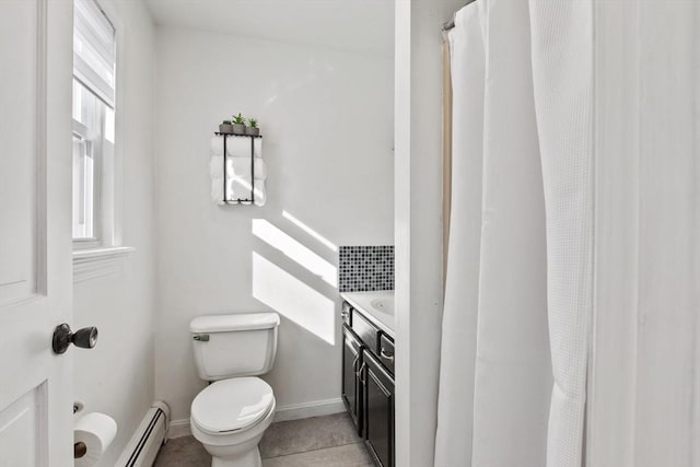 bathroom with tile patterned flooring, vanity, a baseboard heating unit, and toilet