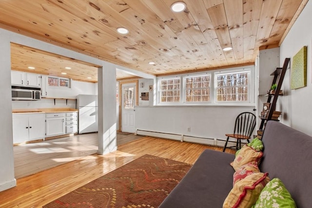 unfurnished living room featuring wood ceiling, a baseboard radiator, and light wood-type flooring