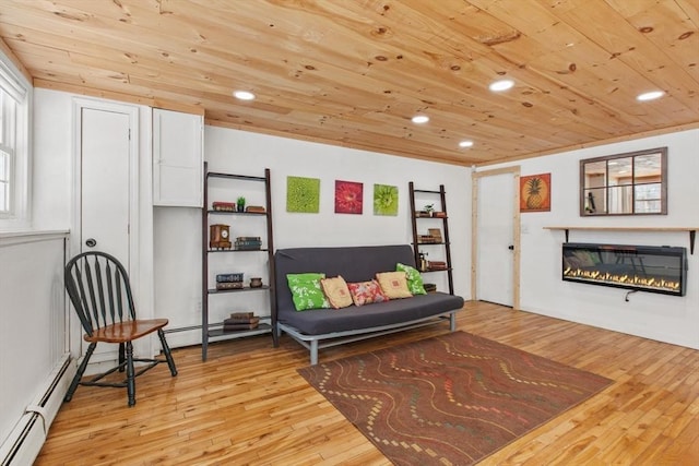 sitting room featuring wood ceiling, a baseboard radiator, and light wood-type flooring