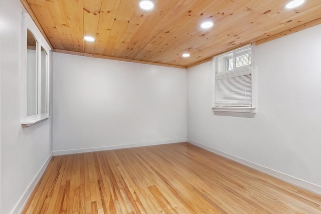 spare room featuring ornamental molding, wooden ceiling, and light wood-type flooring