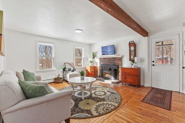 living room with a baseboard radiator, beam ceiling, and light hardwood / wood-style floors