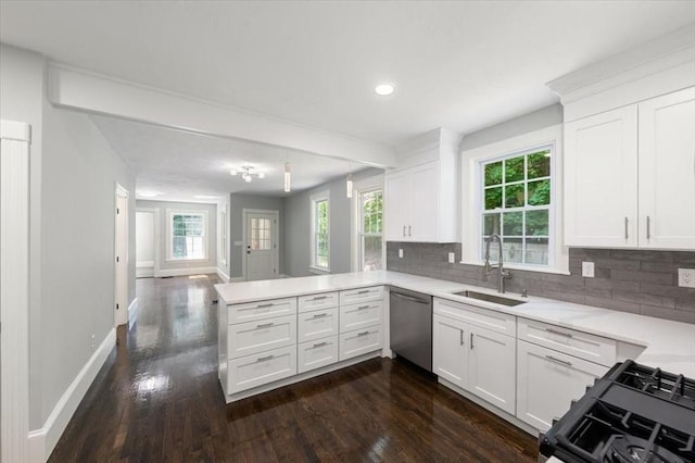68 Putnam St, Weymouth, MA 02189 - kitchen featuring dishwasher, a sink, a peninsula, baseboards, and stove