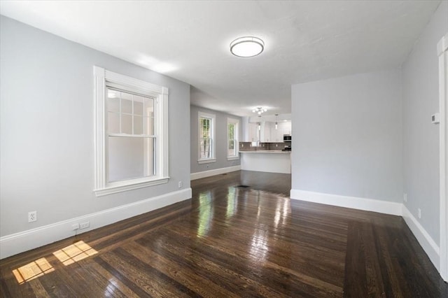 68 Putnam St, Weymouth, MA 02189 - unfurnished living room featuring baseboards and dark wood-style flooring
