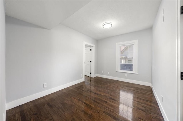 68 Putnam St, Weymouth, MA 02189 - empty room with dark wood-type flooring and baseboards