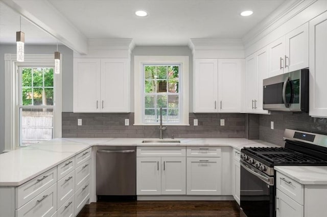 68 Putnam St, Weymouth, MA 02189 - kitchen with stainless steel appliances, healthy amount of natural light, a peninsula, a sink, and recessed lighting