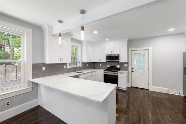 68 Putnam St, Weymouth, MA 02189 - kitchen with stainless steel appliances, a sink, baseboards, tasteful backsplash, and white cabinets