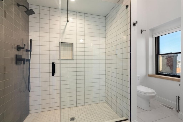 full bath with visible vents, a stall shower, toilet, and baseboards