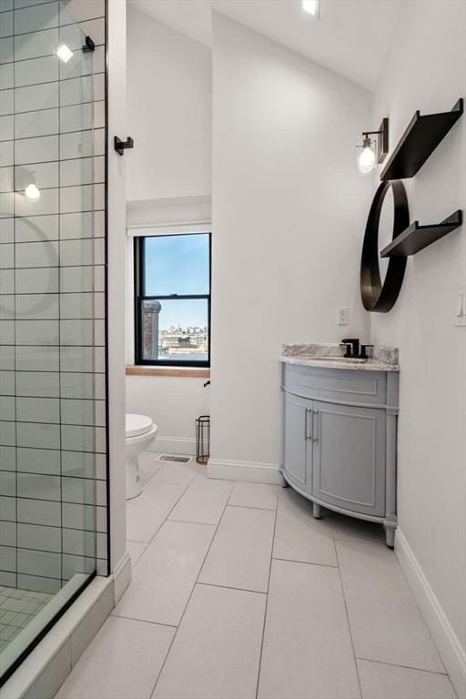 full bath featuring vanity, a shower stall, toilet, and baseboards