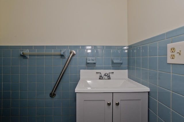 bathroom with vanity, tile walls, and wainscoting