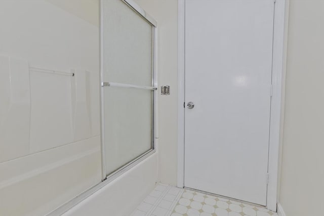 full bathroom with tile patterned floors and shower / bath combination with glass door