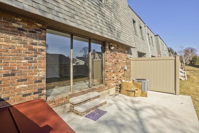 view of patio with entry steps and central AC