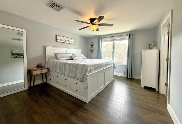 bedroom featuring visible vents, baseboards, and dark wood finished floors