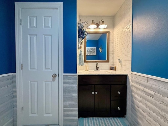 bathroom featuring a wainscoted wall and vanity