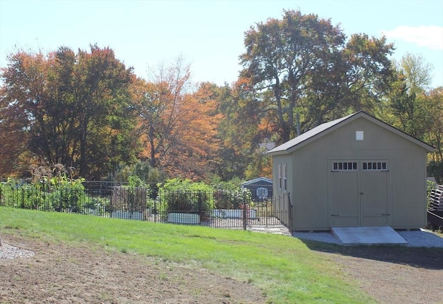 garage featuring a shed and fence