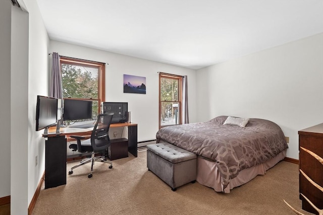 carpeted bedroom with a baseboard heating unit and multiple windows