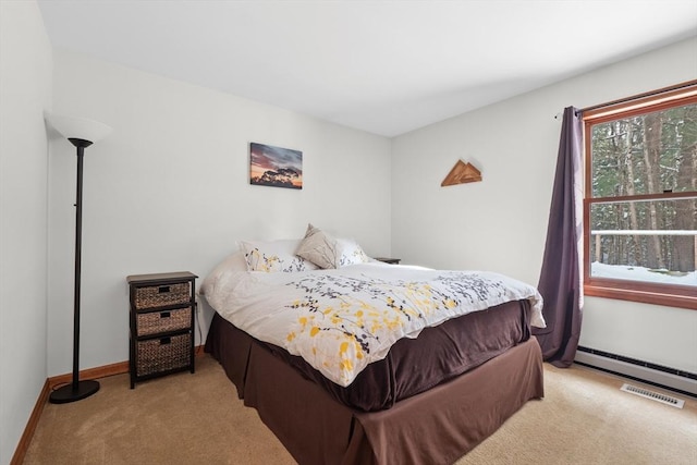 carpeted bedroom featuring a baseboard heating unit