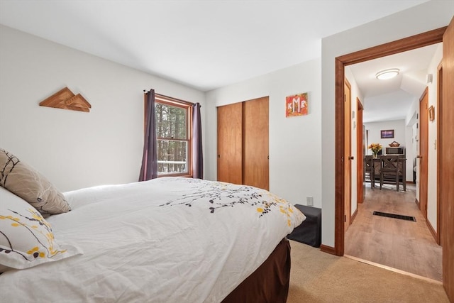 carpeted bedroom featuring a closet