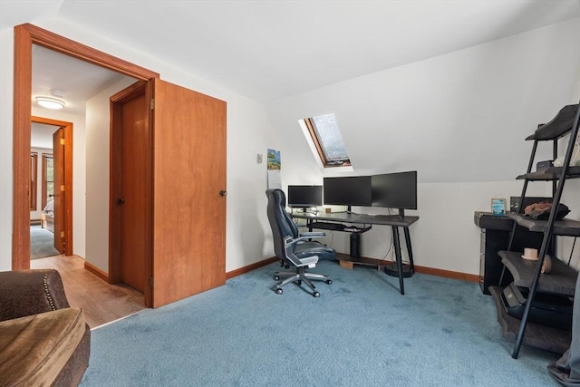 office space with light colored carpet and lofted ceiling with skylight