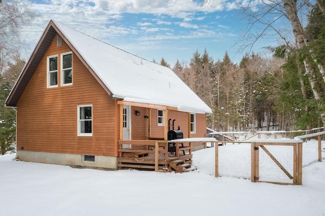 view of snow covered rear of property