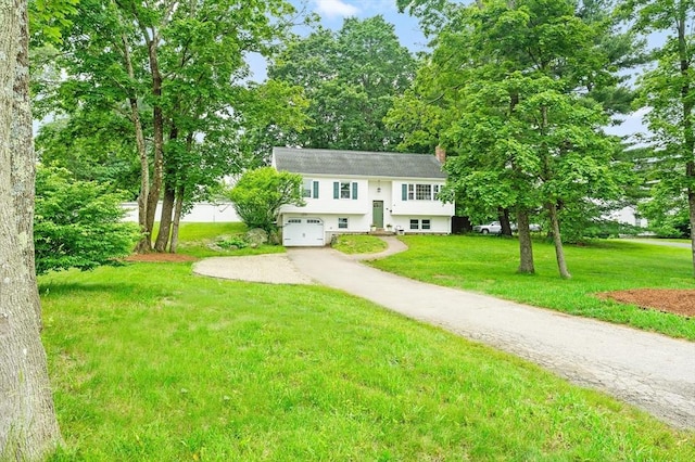 26 W Park St, Franklin, MA 02038 - split foyer home featuring asphalt driveway, a front lawn, a garage, and a chimney