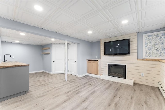 26 W Park St, Franklin, MA 02038 - unfurnished living room with recessed lighting, light wood-style flooring, and a fireplace