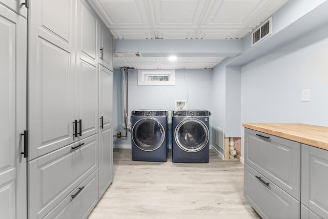 26 W Park St, Franklin, MA 02038 - washroom with washing machine and clothes dryer, light wood-style flooring, and cabinet space