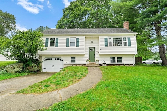 26 W Park St, Franklin, MA 02038 - bi-level home featuring a chimney, driveway, an attached garage, and a front lawn