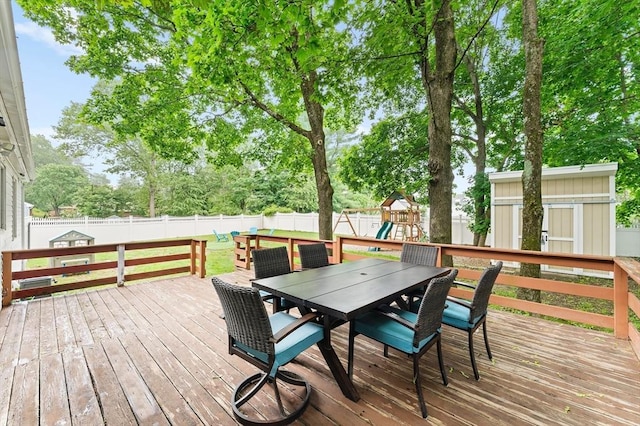 26 W Park St, Franklin, MA 02038 - wooden terrace featuring outdoor dining space, a fenced backyard, a playground, and a shed