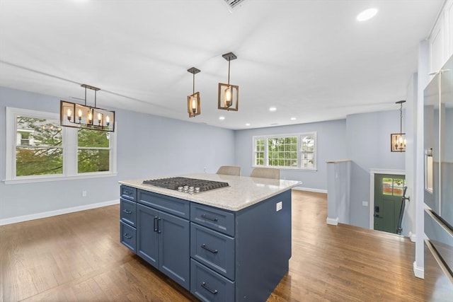 26 W Park St, Franklin, MA 02038 - kitchen with stainless steel gas stovetop, a chandelier, dark wood-style flooring, blue cabinetry, and a kitchen island