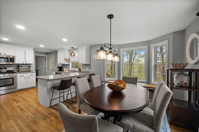 2240 Turnpike St, North Andover, MA 01845 - dining space featuring light wood-style flooring, recessed lighting, and a textured ceiling