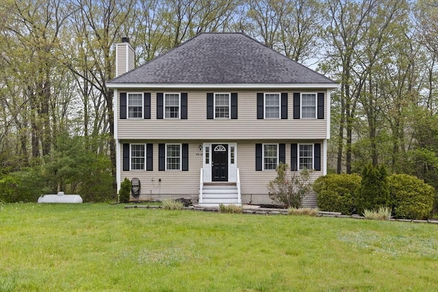 2240 Turnpike St, North Andover, MA 01845 - colonial-style house with a chimney, entry steps, a front yard, and a shingled roof