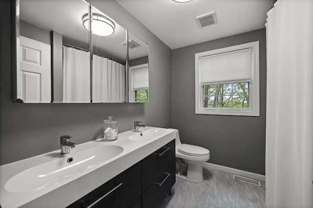 2240 Turnpike St, North Andover, MA 01845 - bathroom with baseboards, toilet, healthy amount of natural light, and double vanity