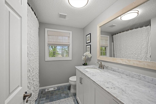 2240 Turnpike St, North Andover, MA 01845 - full bath featuring baseboards, toilet, vanity, and a textured ceiling