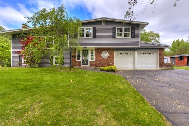 36 Winthrop St, West Boylston, MA 01583 - view of front of house with brick siding, a front lawn, driveway, a garage, and a chimney