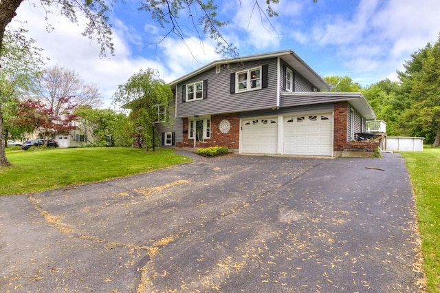 36 Winthrop St, West Boylston, MA 01583 - view of front of home featuring driveway, a front lawn, brick siding, and an attached garage