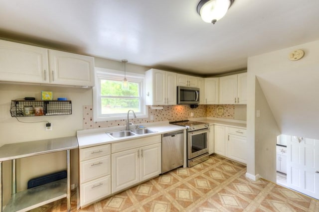 36 Winthrop St, West Boylston, MA 01583 - kitchen featuring appliances with stainless steel finishes, a sink, backsplash, light countertops, and white cabinets