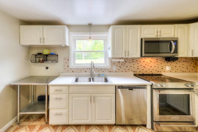 36 Winthrop St, West Boylston, MA 01583 - kitchen with appliances with stainless steel finishes, a sink, decorative backsplash, light countertops, and white cabinets