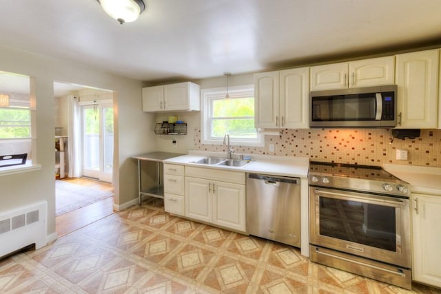 36 Winthrop St, West Boylston, MA 01583 - kitchen with stainless steel appliances, a sink, healthy amount of natural light, and backsplash