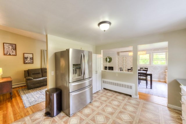 36 Winthrop St, West Boylston, MA 01583 - kitchen featuring stainless steel fridge with ice dispenser, radiator heating unit, a baseboard radiator, an AC wall unit, and light wood-style flooring