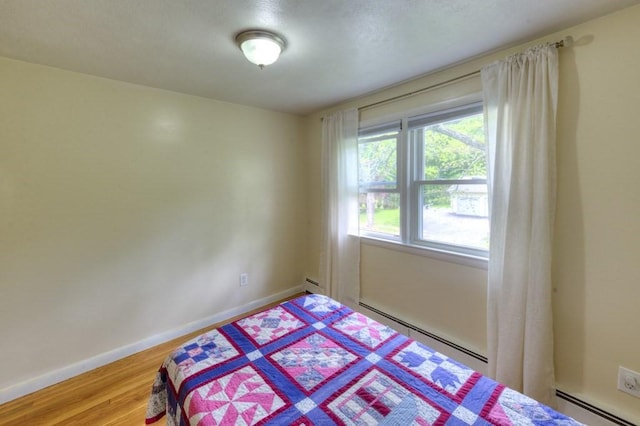 36 Winthrop St, West Boylston, MA 01583 - bedroom featuring baseboard heating, wood finished floors, and baseboards