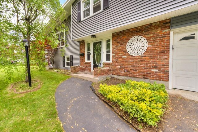 36 Winthrop St, West Boylston, MA 01583 - property entrance with brick siding and a yard